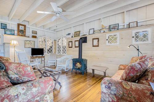 a living room with two couches and a wood stove at Anna's Cottage in Saugatuck