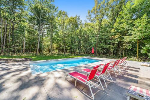 a group of chairs sitting next to a swimming pool at Thunder Road in Fennville