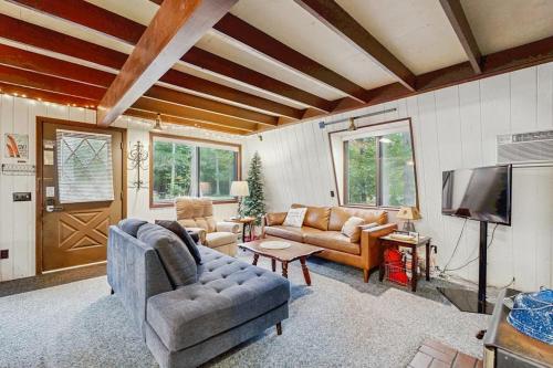 a living room with a couch and a tv at Crystal Chalet in Thompsonville