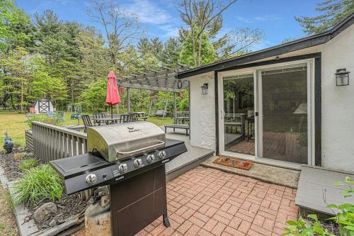 a backyard with a grill and a patio at Tower Hill Cottage in Sawyer