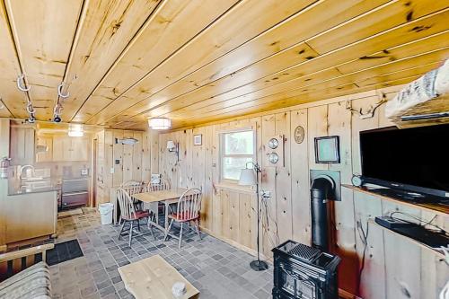 a kitchen and dining room with a table and a tv at Dune Grass Shores in Beulah