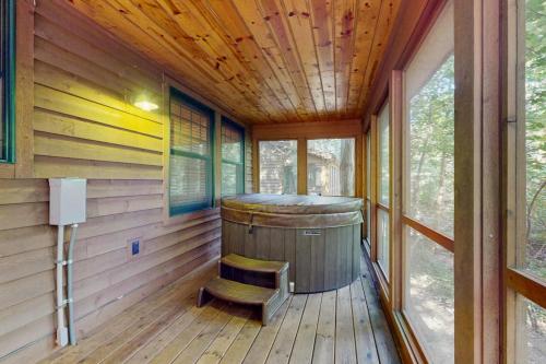 a sauna with a wooden floor and a barrel at Kingfisher Cove Cabin 19 in Saugatuck