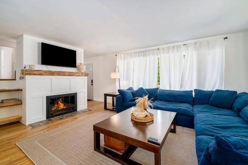 a living room with a blue couch and a fireplace at Gathering Place in Frankfort