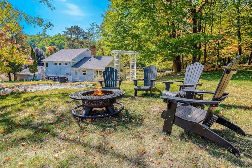 a fire pit and chairs in a yard with a house at Gathering Place in Frankfort
