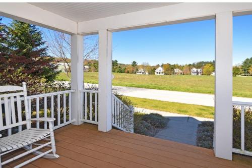 a porch with a bench and a view of a field at Green Glen in Empire