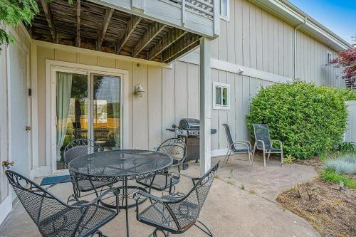a patio with a table and chairs in front of a house at Bluebird Condo in Douglas