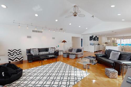 a large living room with couches and a table at Downtown Hideaway in New Buffalo