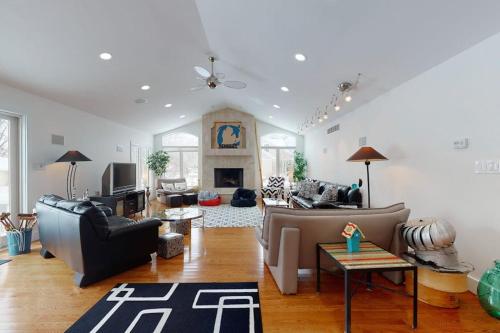 a living room with couches and a fireplace at Downtown Hideaway in New Buffalo