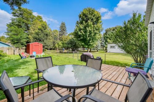 a patio with a table and chairs and a field at Carol's Cottage in Empire