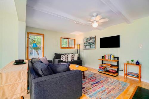 a living room with a couch and a tv at Carol's Cottage in Empire