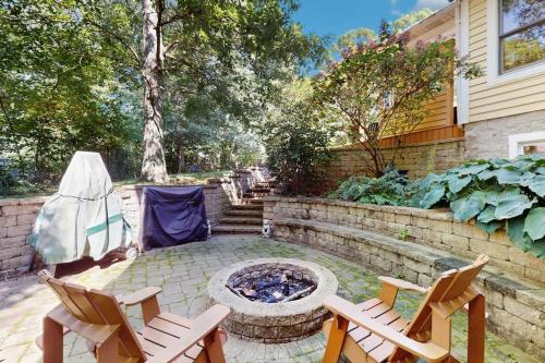 a backyard with two chairs and a fire pit at Grand Getaway in Grand Beach