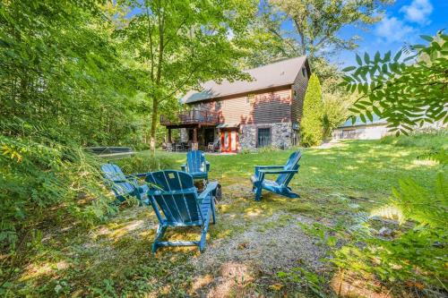 a group of blue chairs in front of a house at The Stonewater Lodge in Traverse City