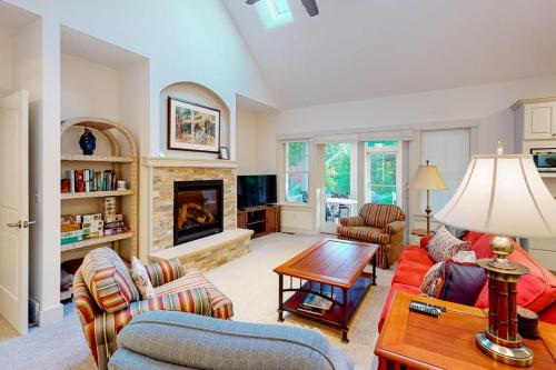 a living room with a couch and a table at Cardinal Corner in Glen Arbor