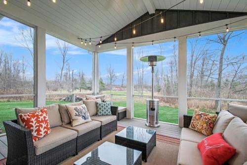 a screened in porch with a couch and a table at Hidden Serenity in Sawyer