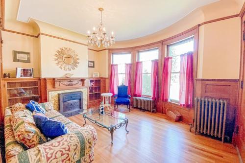 a living room with a couch and a fireplace at The Blacker House in Manistee