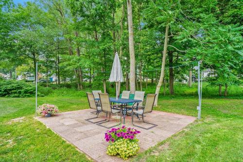 a patio with a table and chairs and an umbrella at South Haven Heaven in South Haven