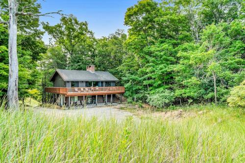 a house sitting in the middle of a forest at Dune House in Manistee