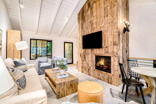 a living room with a couch and a fireplace at Dune House in Manistee