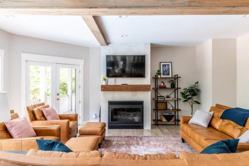 a living room with couches and a fireplace at Mac's Bluff in Grand Beach
