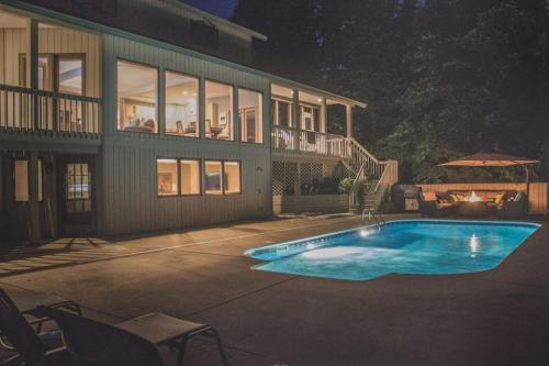 a swimming pool in front of a house at Mac's Bluff in Grand Beach