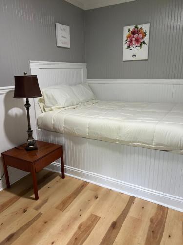 a bedroom with two beds and a table with a lamp at Brooklyn's Tiny Apartment Pets Welcome in North Little Rock