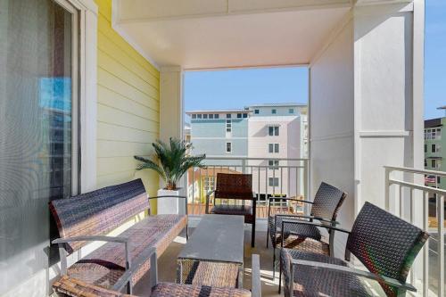 a balcony with chairs and a table on a balcony at The Sanctuary - Blue Lagoon A323 in Virginia Beach