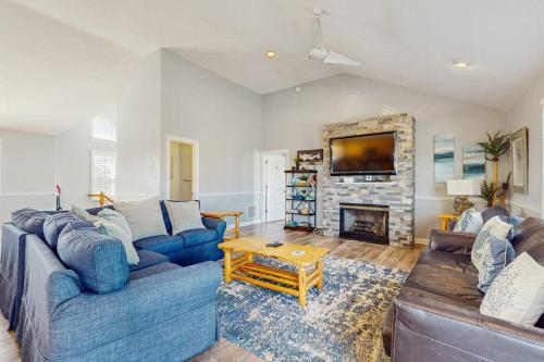 a living room with a blue couch and a fireplace at Down By The Sea in Virginia Beach
