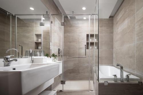 a bathroom with a shower and a sink and a tub at Angkor Mansion & Apartment in Siem Reap