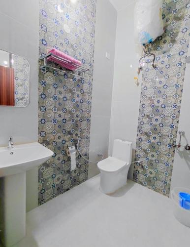 a bathroom with a toilet and a shower at Thano Retreat in Dehradun