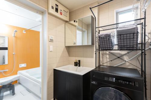 a washing machine in a bathroom with a sink at The Ichikawa House in Ichikawa