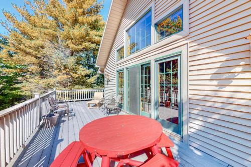 a red table and chairs on a deck at Ridge Wood in Empire