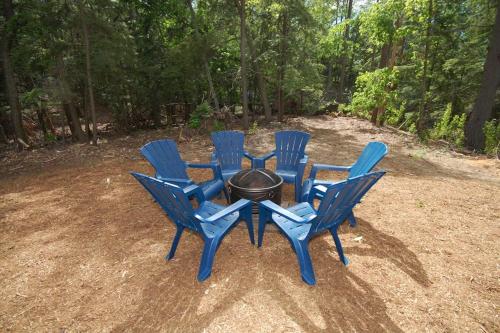 a group of blue chairs around a fire pit at Dunes Trail in Glen Arbor