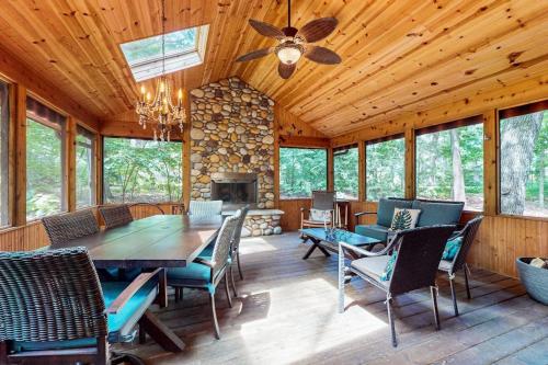 a dining room with a table and chairs and a fireplace at The Tree House in New Buffalo