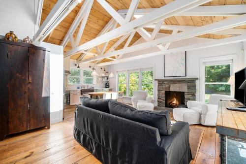 a living room with couches and a fireplace at White Pines Cottage in Glen Arbor