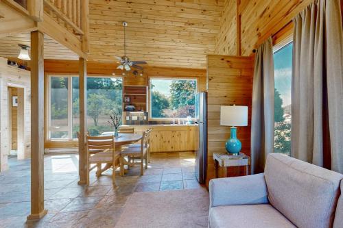 a kitchen and dining room with a table and chairs at Green Pastures in Maple City