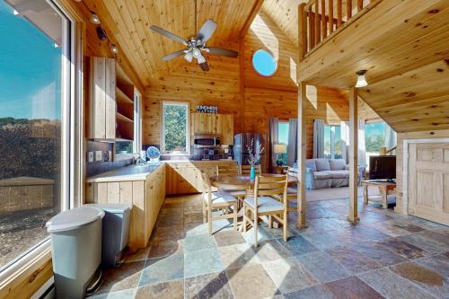 a kitchen and living room with a wooden ceiling at Green Pastures in Maple City