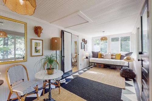 a living room with a bed and a table and chairs at Lilly Bell Villa in Three Oaks