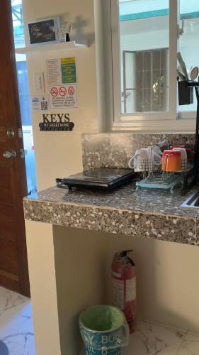 a kitchen counter with a sink and a counter top at Emtri Apartments in Sipak