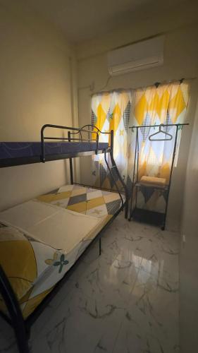 a small room with two bunk beds in it at Emtri Apartments in Sipak