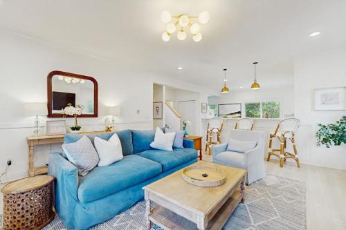a living room with a blue couch and a table at Wrightwood Cottage in South Haven