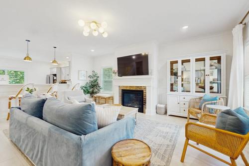 a living room with a blue couch and a fireplace at Wrightwood Cottage in South Haven