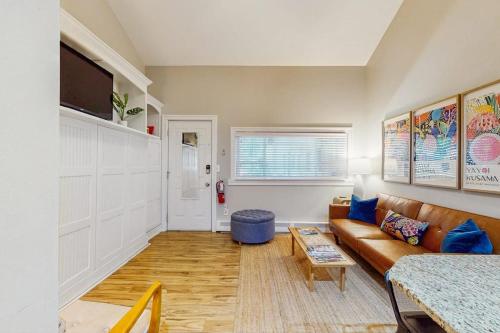 a living room with a couch and a table at Arrowhead Resort - Stylish Retro Escape in Saugatuck