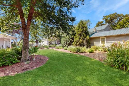 a yard with a house and a tree at Arrowhead Resort - Stylish Retro Escape in Saugatuck