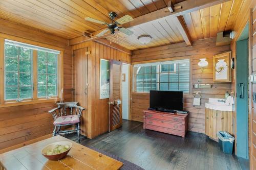 a living room with a television and a sink and a table at Peterson Mill in Saugatuck