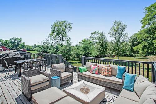 a patio with couches and a table and a grill at Three Oaks Retreat in Three Oaks