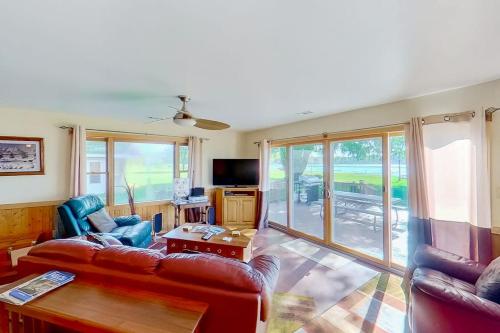 a living room with a couch and a table at The Summer House in Onekama