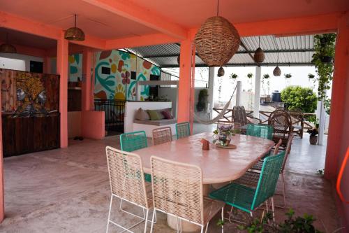 a table and chairs on an outdoor patio at Casa de Rosa in Puerto Escondido