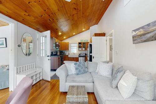 a living room with a couch and a kitchen at Fresh Pond Chateau in Oak Bluffs