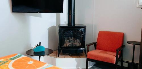 a room with a fireplace and a chair and a bed at Myles Standish in Provincetown