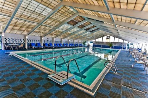 a large swimming pool with an open ceiling at Fairway Bliss at Ocean Edge in Brewster